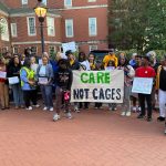 JUFJ and our partners holding up signs advocating for youth justice and "Care, not Cages"