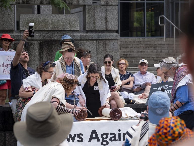 Jewish clergy, surrounded by JUFJers and allies, reading Torah on Tisha B'Av